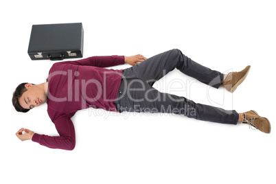 High angle view of businessman sleeping by briefcase