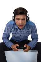 Portrait of young businessman playing video game