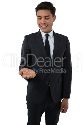 Smiling businessman looking at palm of hand