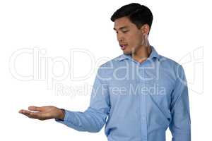 Businessman looking at hand while standing