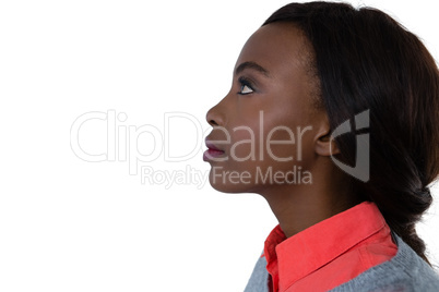 Side view of young woman looking up