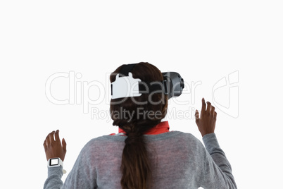 Rear view of female gesturing while using vr glasses