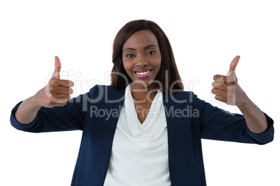 Portrait of happy businesswoman showing thumbs up