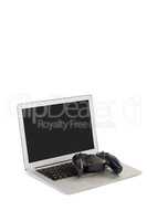 Joystick and laptop on white background