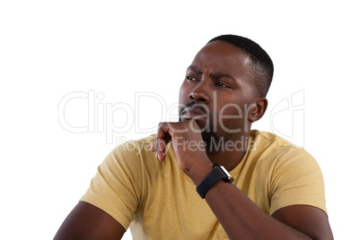 Man with hand on chin against white background