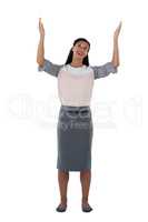 Businesswoman standing with hands raised