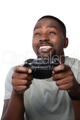 Smiling man playing video game against white background