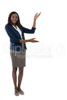 Full length portrait of businesswoman gesturing during presentation