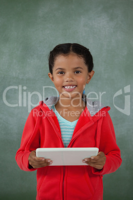 Young girl holding digital tablet