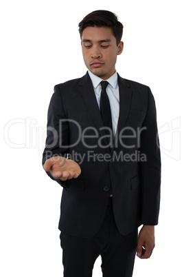 Businessman looking at palm of hand
