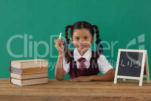 Schoolgirl calculating sums at desk