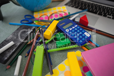 Various school supplies on chalkboard