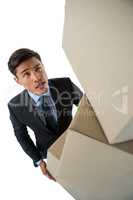 High angle view of businessman carrying cardboard boxes