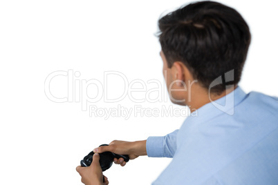 Rear view of businessman playing video game