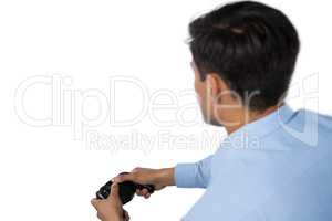 Rear view of businessman playing video game