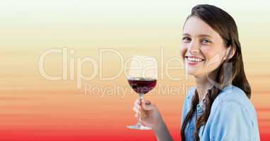 Millennial woman tasting wine against blurry red and peach background