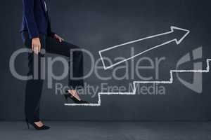 Business woman climbing stairs against blue background with white arrow