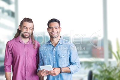 Happy business people holding a tablet