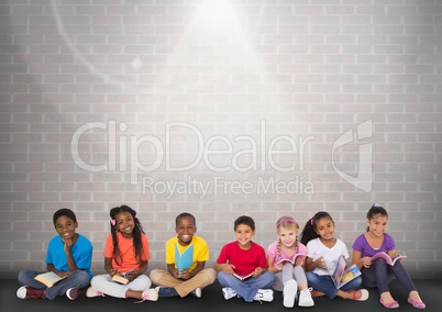 Group of children sitting in front of brick grey background