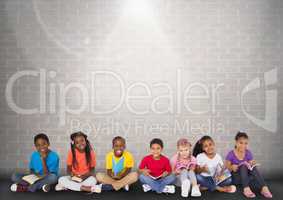 Group of children sitting in front of brick grey background