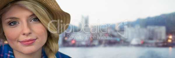 Portraiture of millennial woman with sun hat against blurry skyline