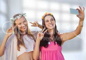 Women taking casual selfie photo in front of blurred background