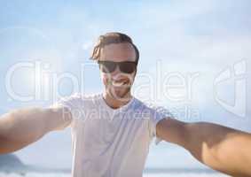 Man taking casual selfie photo in front of sea sky