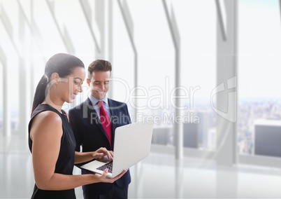 Happy business people looking at a computer