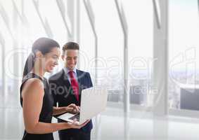 Happy business people looking at a computer