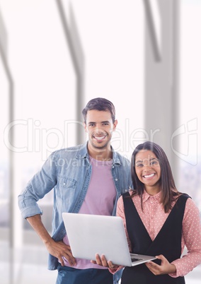 Happy business people holding a computer