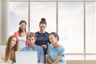 Business people at a desk looking at a computer