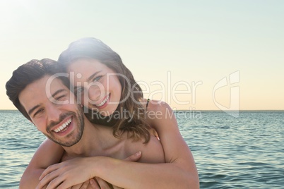 Happy couple at the beach embracing