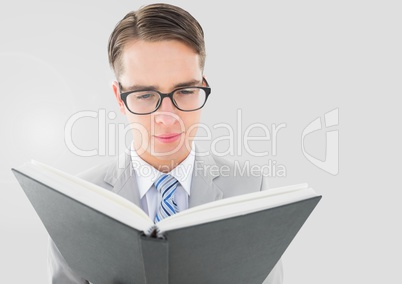 Portrait of Man reading book with grey background