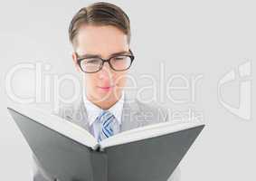 Portrait of Man reading book with grey background