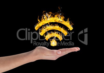 Hand holding fiery wifi symbol over black background