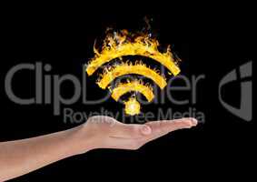 Hand holding fiery wifi symbol over black background
