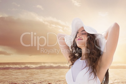 Woman at the beach closing her eyes