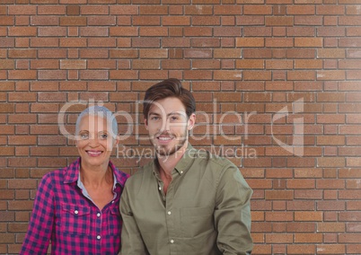 Business people standing against brick wall