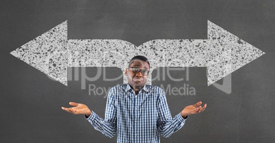 Confused business man standing against grey background with white arrows