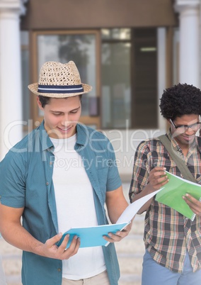 Students reading exam results in front of building door