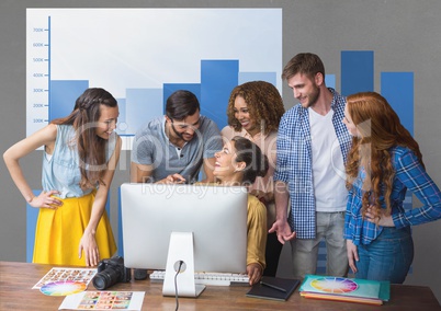 Happy business people at a desk talking against grey background with blue graphics