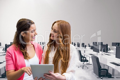 Happy business women using a tablet