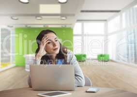 Worried business woman at a desk using a computer