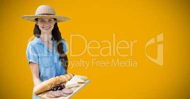 Woman with food platter against yellow background