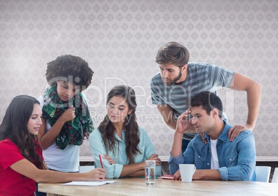 Group of friends sitting in front of blank grey background