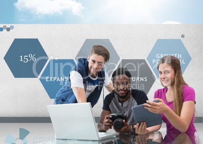 Group of young people on computer with camera in front of business graphics