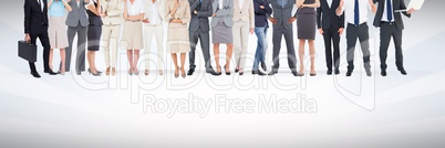 Group of business people standing in front of blank grey background