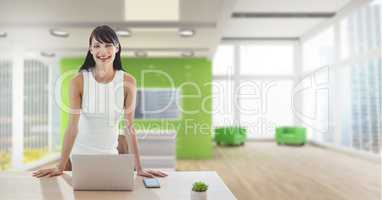 Happy business woman at a desk using a computer
