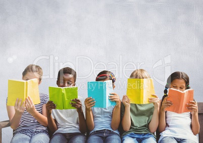 Group of children sitting and reading in front of grey background