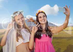 Women taking casual selfie photo in front of mountain landscape